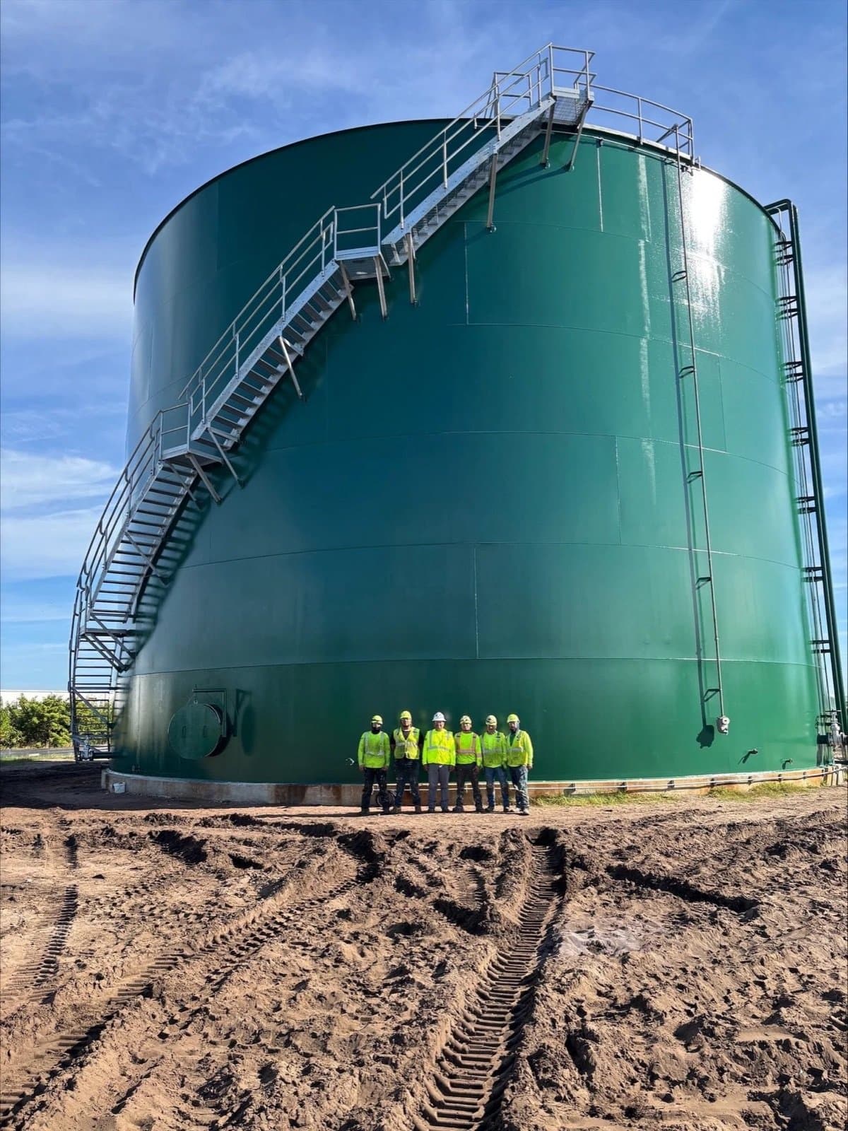 Crew standing at the base of the completed tank